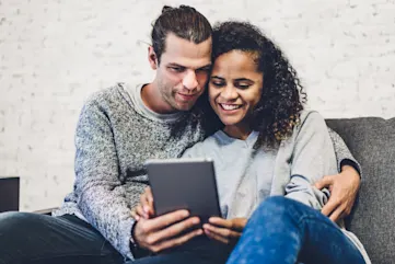 a man and woman sitting on a couch
